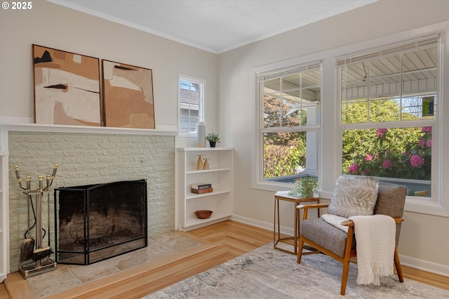 7817 N Washburne Ave, Portland, OR 97217 - living area featuring crown molding, a fireplace with raised hearth, and baseboards