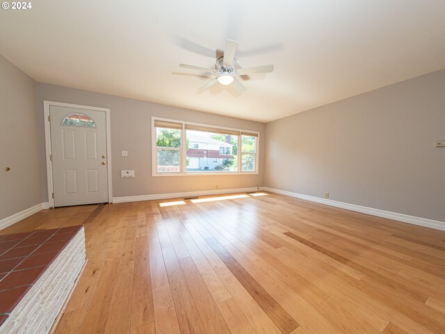 51055109 SE Tibbetts St, Portland, OR 97206 - unfurnished living room featuring ceiling fan, light wood-type flooring, arched walkways, and baseboards