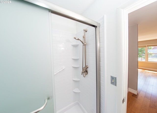 51055109 SE Tibbetts St, Portland, OR 97206 - bathroom with a shower stall, hardwood / wood-style flooring, and baseboards