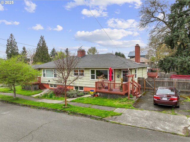 51055109 SE Tibbetts St, Portland, OR 97206 - view of front of house featuring a chimney, a wooden deck, and roof with shingles