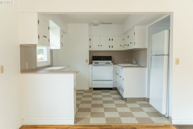 51055109 SE Tibbetts St, Portland, OR 97206 - kitchen featuring white appliances, a sink, light flooring, white cabinetry, and light countertops