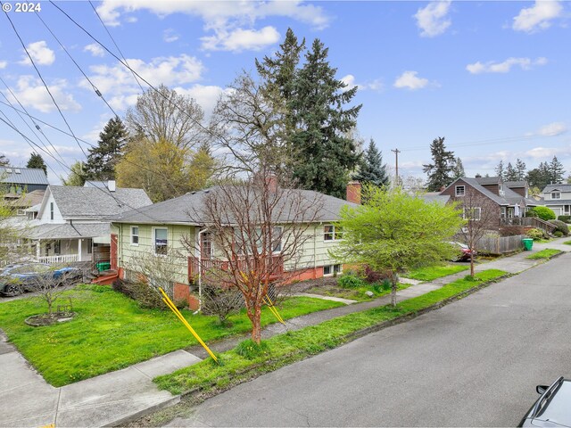 51055109 SE Tibbetts St, Portland, OR 97206 - view of front of home featuring a residential view, a chimney, and a front yard