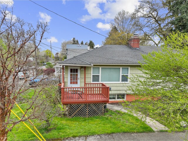 51055109 SE Tibbetts St, Portland, OR 97206 - view of front of home featuring a shingled roof, a chimney, and a deck