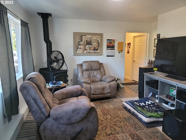 130 Aker Dr, Myrtle Creek, OR 97457 - living area featuring wood finished floors, a wood stove, and baseboards