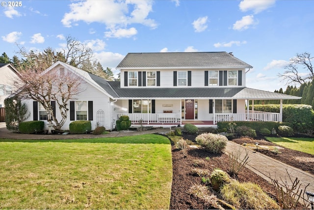 view of front of property with a front yard and covered porch