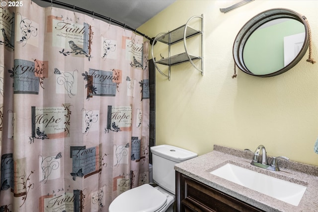 full bath featuring toilet, vanity, and curtained shower