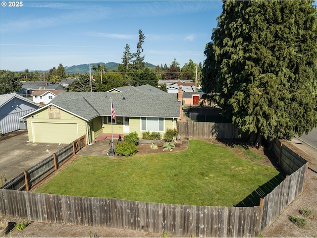 view of front of property with asphalt driveway, a mountain view, a garage, and a shingled roof