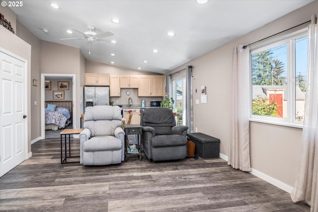 living area featuring vaulted ceiling, recessed lighting, ceiling fan, wood finished floors, and baseboards
