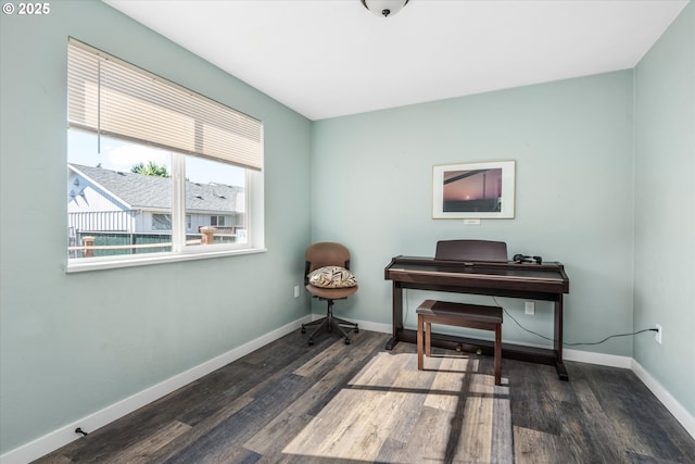 sitting room with dark wood-style floors, baseboards, and a desk