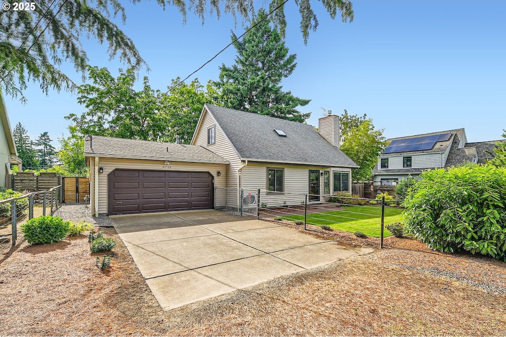 4719 NE 70th Ave, Portland, OR 97218 - view of front of home featuring an attached garage, driveway, a chimney, and a shingled roof