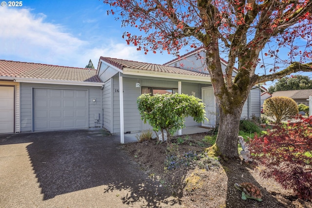 1616 N Johnson Dr, Newberg, OR 97132 - view of front facade featuring an attached garage, a tile roof, and aphalt driveway