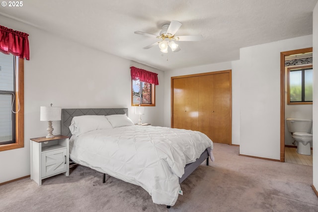 1616 N Johnson Dr, Newberg, OR 97132 - carpeted bedroom featuring baseboards, a ceiling fan, a closet, and ensuite bath