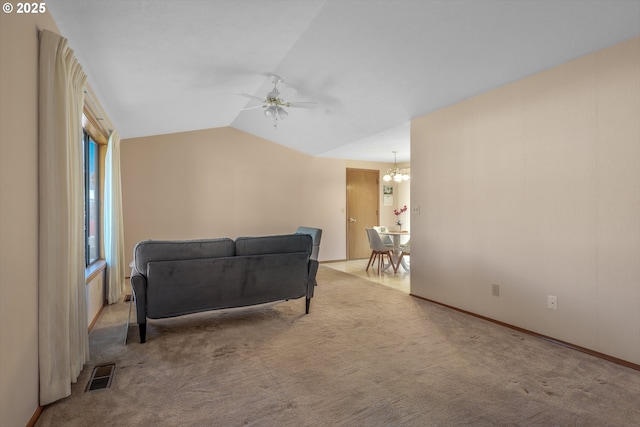 1616 N Johnson Dr, Newberg, OR 97132 - living area with carpet flooring, ceiling fan with notable chandelier, baseboards, lofted ceiling, and visible vents