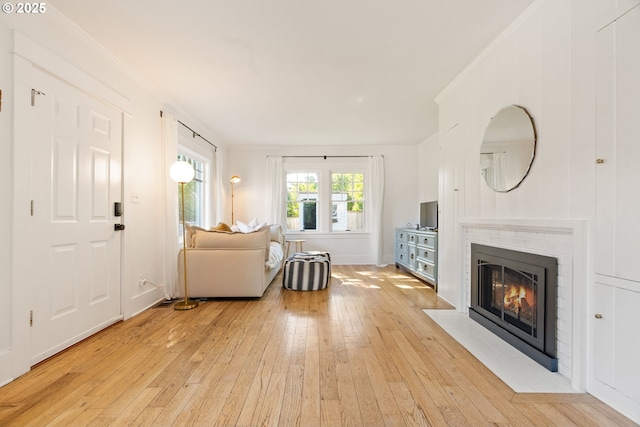 7985 SW Maple Dr, Portland, OR 97225 - living room featuring light wood finished floors, crown molding, and a fireplace with flush hearth