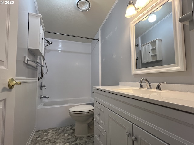 bathroom with shower / bathtub combination, toilet, ornamental molding, a textured ceiling, and vanity