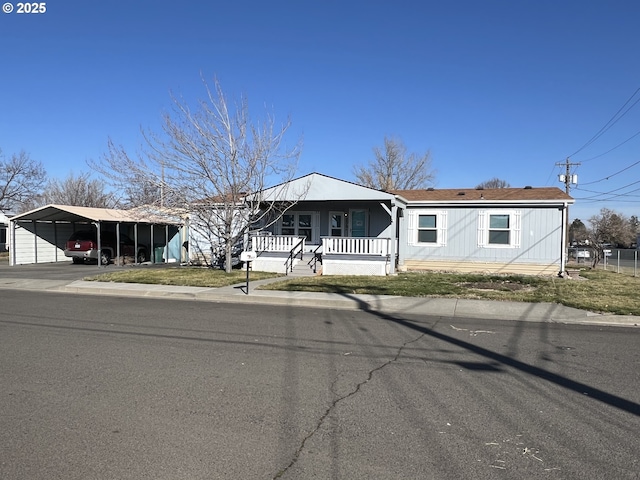 view of front facade featuring a porch and a detached carport