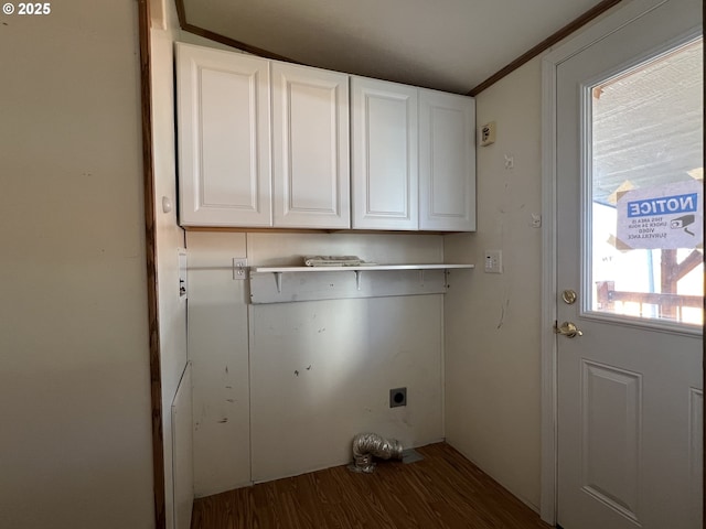 laundry room with cabinet space, electric dryer hookup, and wood finished floors