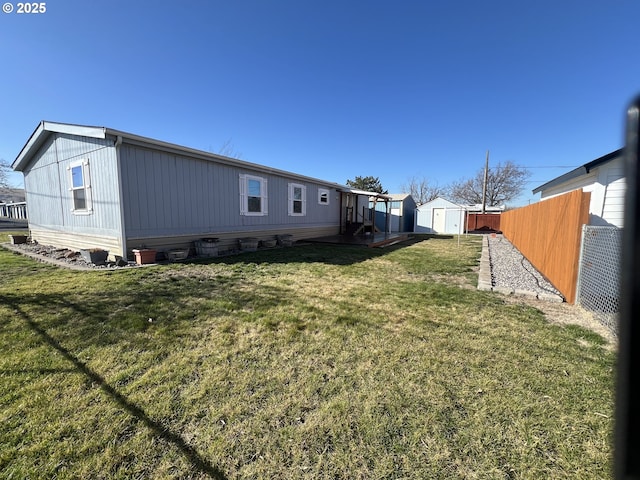 view of yard featuring an outdoor structure, fence, and a storage shed