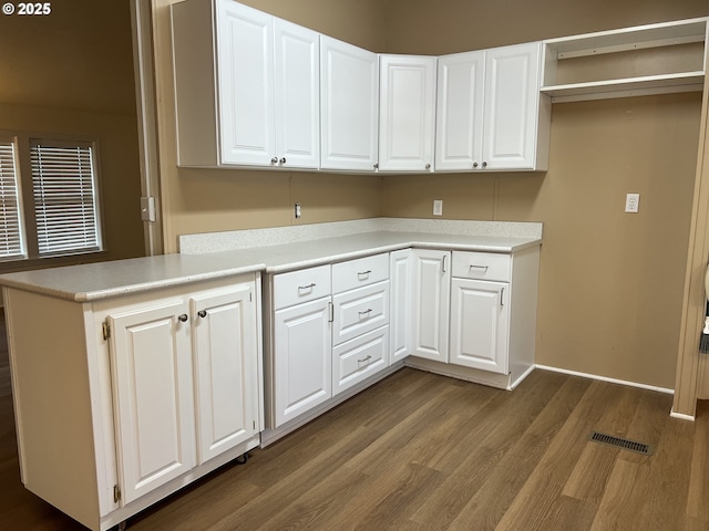 clothes washing area featuring visible vents, dark wood finished floors, and baseboards