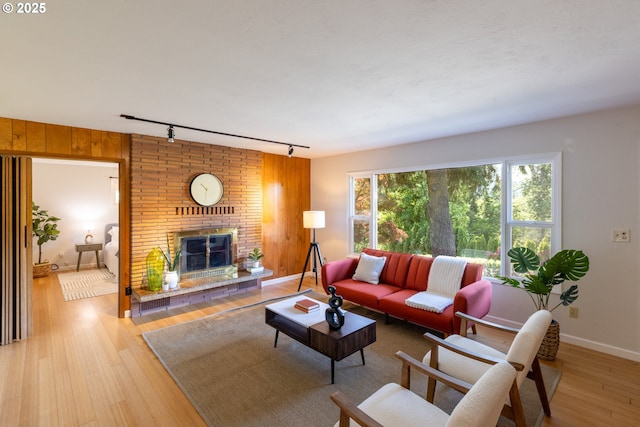1379 Tucker Rd, Hood River, OR 97031 - living room with track lighting, wood finished floors, a fireplace, and baseboards