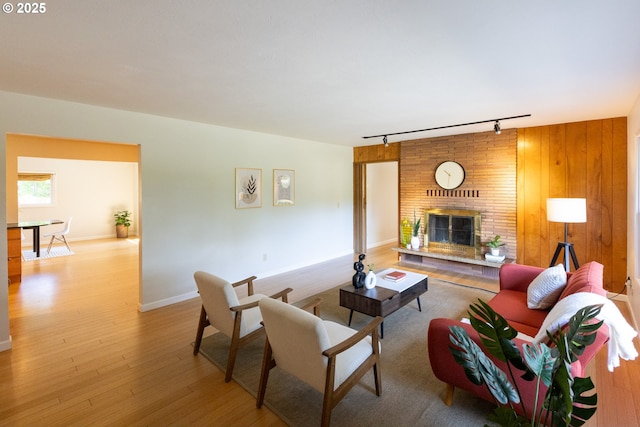 1379 Tucker Rd, Hood River, OR 97031 - living area featuring track lighting, wood finished floors, a brick fireplace, and baseboards