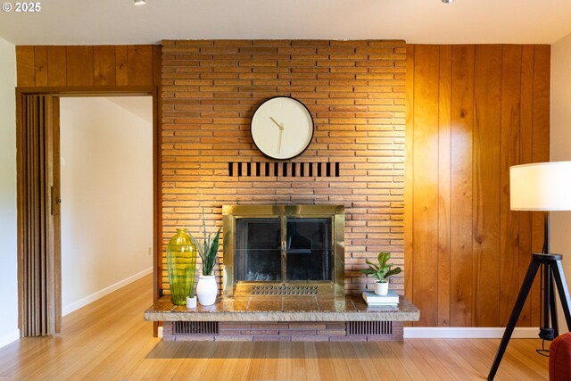 1379 Tucker Rd, Hood River, OR 97031 - detailed view of wood finished floors, a brick fireplace, baseboards, and wooden walls