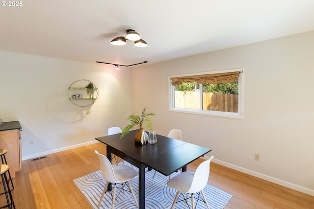1379 Tucker Rd, Hood River, OR 97031 - dining room with baseboards, light wood-style floors, and rail lighting