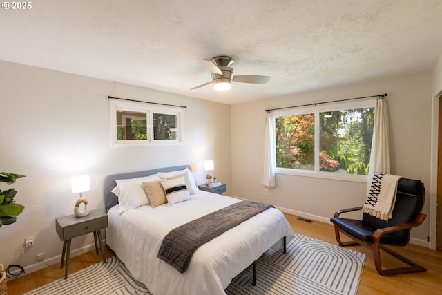 1379 Tucker Rd, Hood River, OR 97031 - bedroom with light wood finished floors, baseboards, and ceiling fan