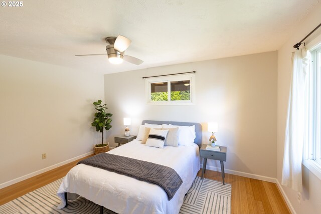 1379 Tucker Rd, Hood River, OR 97031 - bedroom featuring wood finished floors, multiple windows, and ceiling fan