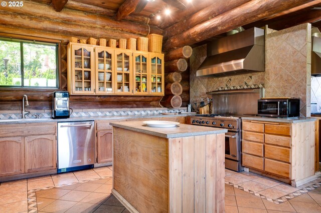 34643 Mountain View Pl NE, Albany, OR 97322 - kitchen with wall chimney range hood, stainless steel appliances, a sink, light tile patterned floors, and rustic walls