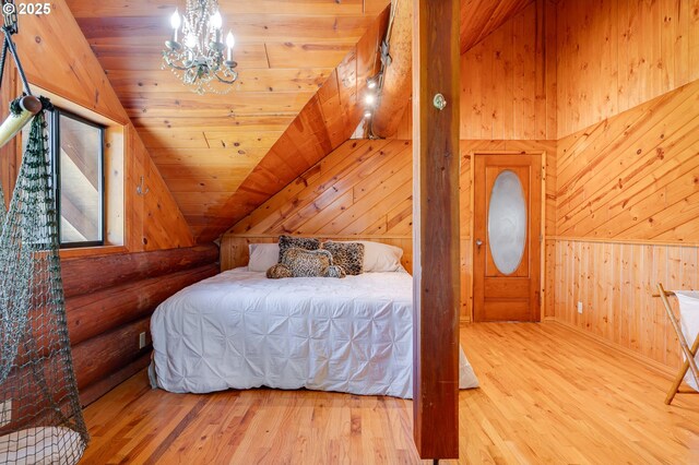 34643 Mountain View Pl NE, Albany, OR 97322 - bedroom featuring lofted ceiling, hardwood / wood-style flooring, wooden walls, a chandelier, and wooden ceiling
