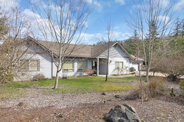 view of front of property with a front lawn and a garage