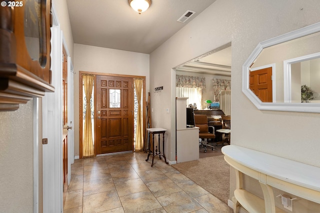 entrance foyer with tile patterned floors and visible vents