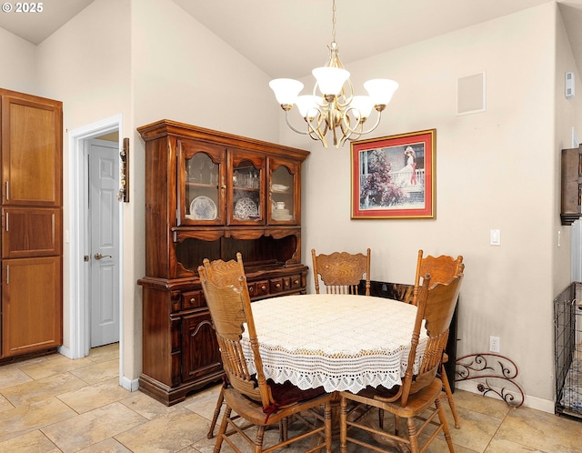 dining space with lofted ceiling, baseboards, and a chandelier