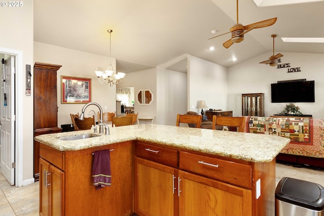 23164 N Umpqua Hwy, Idleyld Park, OR 97447 - kitchen featuring open floor plan, vaulted ceiling, an island with sink, light stone countertops, and ceiling fan