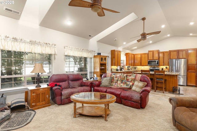 living room with high vaulted ceiling, a ceiling fan, visible vents, and light carpet