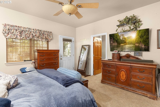 bedroom with light colored carpet and a ceiling fan