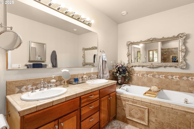 bathroom with a sink, a garden tub, and double vanity