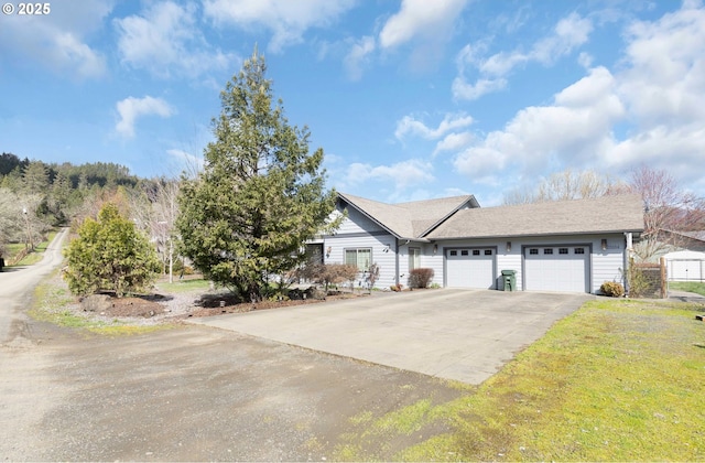 ranch-style home featuring an attached garage and driveway