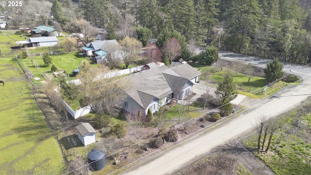 birds eye view of property with a view of trees