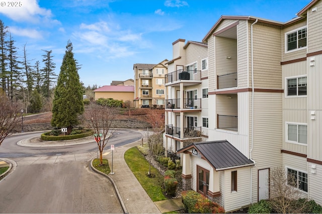 view of street featuring a residential view and curbs