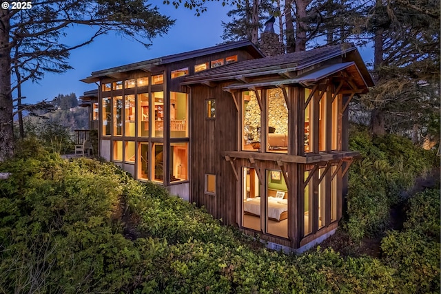 view of back house at dusk