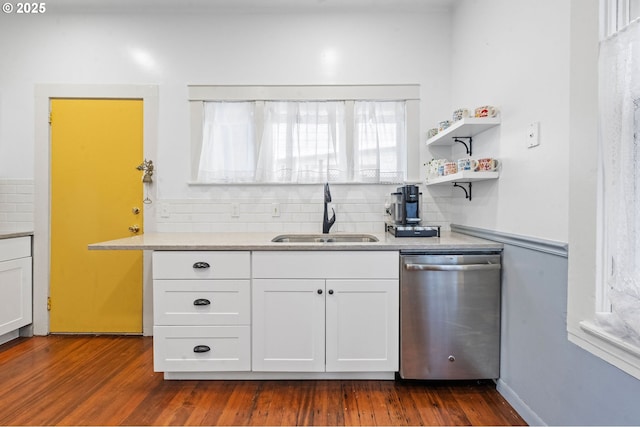 kitchen with dishwasher, a sink, backsplash, white cabinets, and light countertops