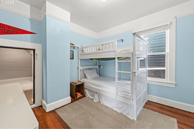 bedroom featuring wood finished floors and baseboards