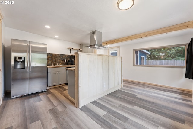 89311 Sutton Lake Dr, Florence, OR 97439 - kitchen featuring stainless steel fridge, island exhaust hood, tasteful backsplash, light wood-type flooring, and gray cabinets