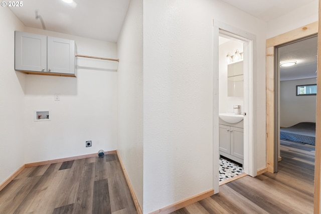 89311 Sutton Lake Dr, Florence, OR 97439 - washroom with cabinet space, wood finished floors, hookup for a washing machine, and hookup for an electric dryer