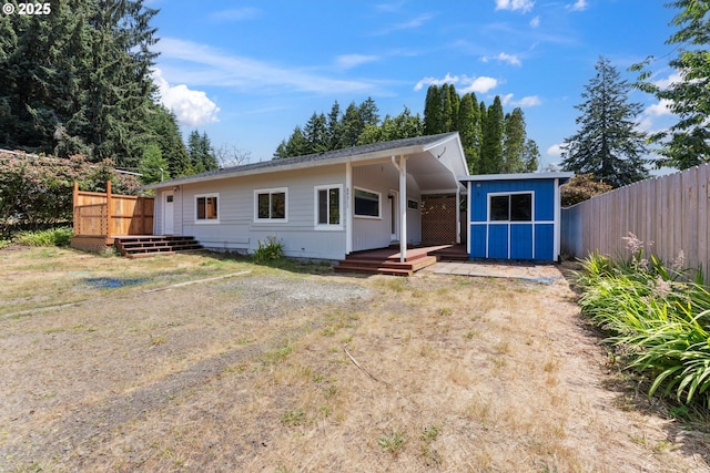 89311 Sutton Lake Dr, Florence, OR 97439 - view of front of house featuring a deck and a storage unit