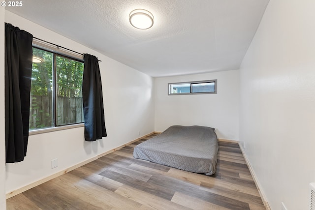89311 Sutton Lake Dr, Florence, OR 97439 - bedroom with wood finished floors and a textured ceiling