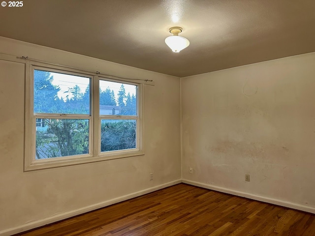 empty room featuring dark hardwood / wood-style flooring