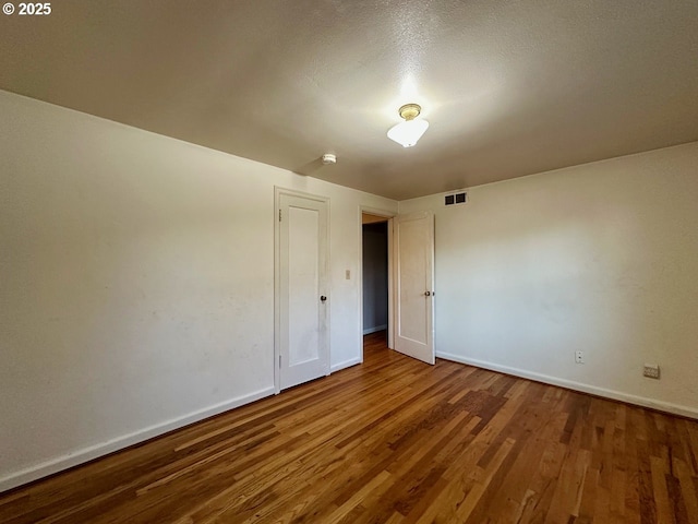 empty room with wood-type flooring